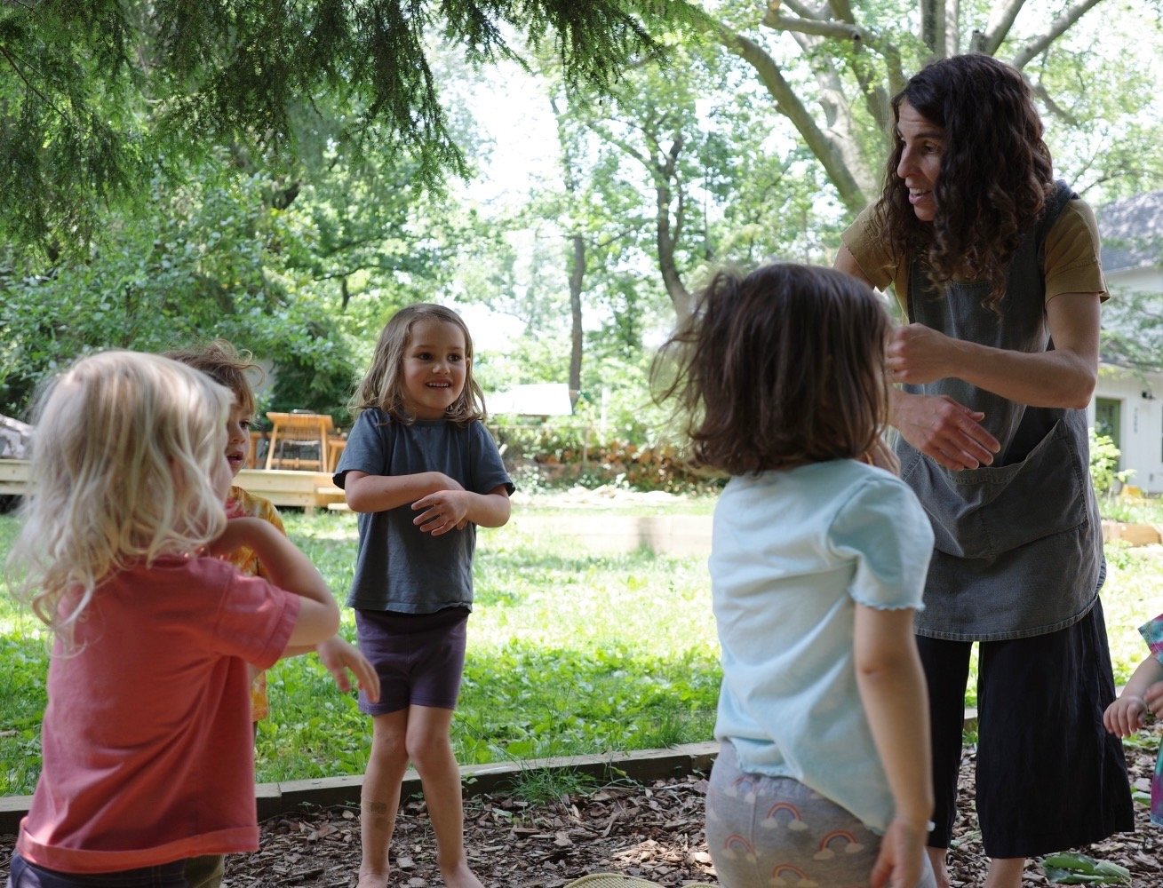 Jenia playing with children in the garden
